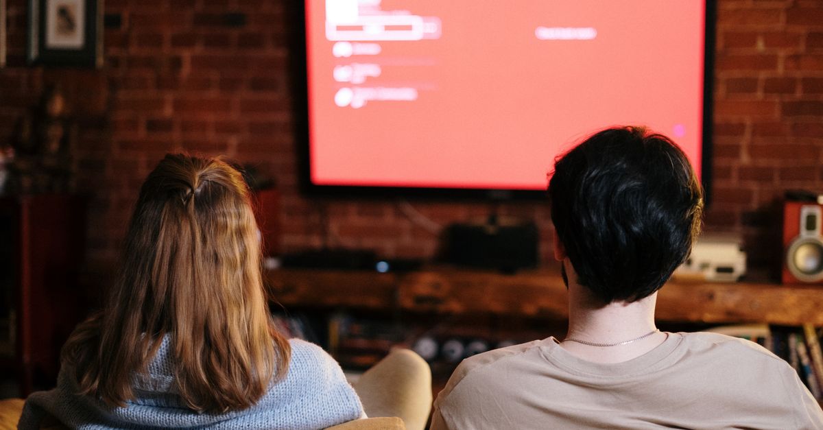 People watching a TV series together on a sofa